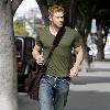 Kellan Lutz out and about in Beverly Hills while carrying a brown messenger bag Los Angeles.