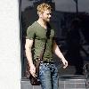 Kellan Lutz out and about in Beverly Hills while carrying a brown messenger bag Los Angeles.