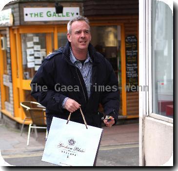 Norman Cook aka Fat Boy Slimshopping at 'Gresham Blake' a Tailored Suit Store in Brighton. Sussex.