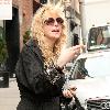 Courtney Love out and about in Soho wearing pajamas and smoking a cigarette New York City.