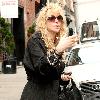 Courtney Love out and about in Soho wearing pajamas and smoking a cigarette New York City.