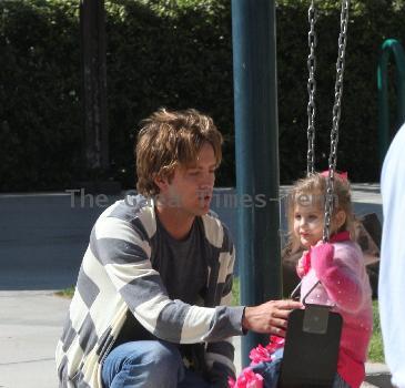 Larry Birkhead 
playing with his daughter, Dannielynn Birkhead, at a park
Los Angeles, California.