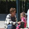 Larry Birkhead 
playing with his daughter, Dannielynn Birkhead, at a park
Los Angeles, California.