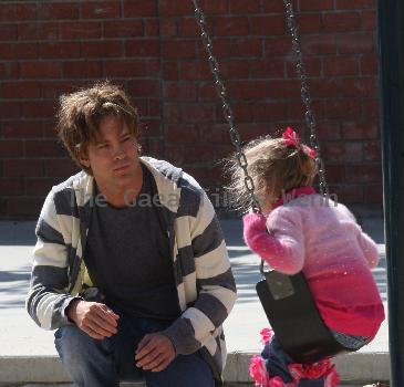 Larry Birkhead 
playing with his daughter, Dannielynn Birkhead, at a park
Los Angeles, California.