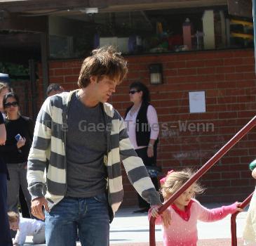 Larry Birkhead 
playing with his daughter, Dannielynn Birkhead, at a park
Los Angeles, California.