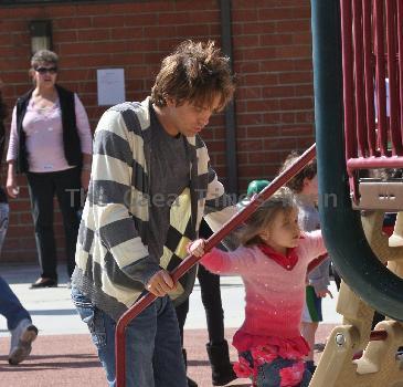 Larry Birkhead 
playing with his daughter, Dannielynn Birkhead, at a park
Los Angeles, California.