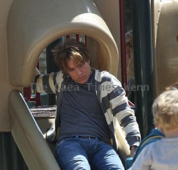 Larry Birkhead 
playing with his daughter, Dannielynn Birkhead, at a park
Los Angeles, California.