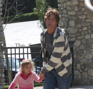 Larry Birkhead 
playing with his daughter, Dannielynn Birkhead, at a park
Los Angeles, California.