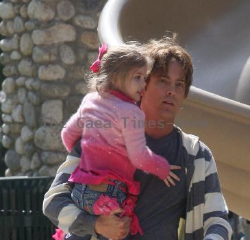 Larry Birkhead 
playing with his daughter, Dannielynn Birkhead, at a park
Los Angeles, California.