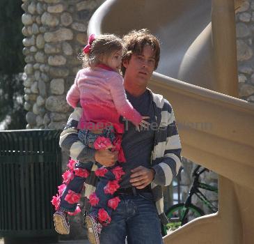 Larry Birkhead 
playing with his daughter, Dannielynn Birkhead, at a park
Los Angeles, California.