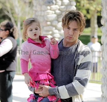 Larry Birkhead 
playing with his daughter, Dannielynn Birkhead, at a park 
Los Angeles, California.