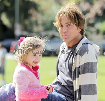 Larry Birkhead 
playing with his daughter, Dannielynn Birkhead, at a park 
Los Angeles, California.