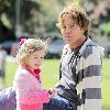 Larry Birkhead 
playing with his daughter, Dannielynn Birkhead, at a park 
Los Angeles, California.