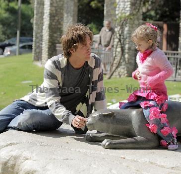 Larry Birkhead 
playing with his daughter, Dannielynn Birkhead, at a park 
Los Angeles, California.