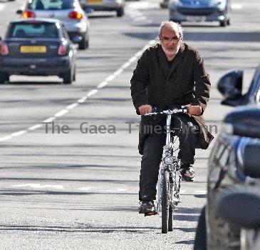 Alan Yentob rides his bicycle in West London London.