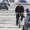 Alan Yentob rides his bicycle in West London London.