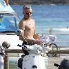 Baz Luhrmann leaves Bondi Beach on his Vespa scooter after a swim. Sydney.