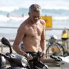 Baz Luhrmann leaves Bondi Beach on his Vespa scooter after a swim. Sydney.