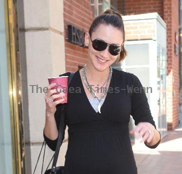 Bree Turner carrying a small Barney's shopping bag and drinking coffee while out and about in Beverly Hills
Los Angeles, California.