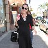 Bree Turner carrying a small Barney's shopping bag and drinking coffee while out and about in Beverly Hills
Los Angeles, California.