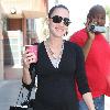 Bree Turner carrying a small Barney's shopping bag and drinking coffee while out and about in Beverly Hills
Los Angeles, California.