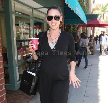 Bree Turner carrying a small Barney's shopping bag and drinking coffee while out and about in Beverly Hills
Los Angeles, California.