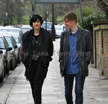 Agyness Deyn with a male friend
takes a stroll. The supermodel with a Canon camera around her neck.
London, England.