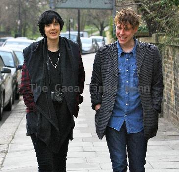 Agyness Deyn with a male friend
takes a stroll. The supermodel with a Canon camera around her neck.
London, England.