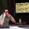 Lukas Haas enjoying a cigar while talking on his phone outside his new bar in West Hollywood.Los Angeles.