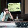 Lukas Haas enjoying a cigar while talking on his phone outside his new bar in West Hollywood.Los Angeles.