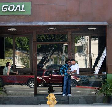 Lukas Haas enjoying a cigar while talking on his phone outside his new bar in West Hollywood.Los Angeles.