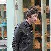 Musician Noel Gallagher 
of Oasis, shops at a grocery supermarket on Marlybone High Street. Afterwards, Noel looks for a bargain in the shop window of Oxfam Books & Music store 
London, England.