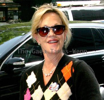 Melanie Griffith 
smoking a cigarette and talking to a friend in Manhattan
New York City, USA.