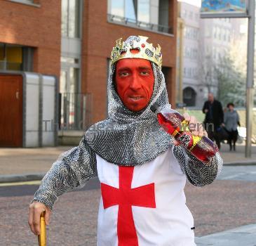 Midget with a red face wearing a St George's Cross, amour suit and crown
promoting 'King Tango' for an adveristing campaign for St Georges Day on the 23rd April.
London, England.