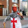 Midget with a red face wearing a St George's Cross, amour suit and crown
promoting 'King Tango' for an adveristing campaign for St Georges Day on the 23rd April.
London, England.