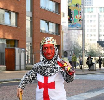 Midget with a red face wearing a St George's Cross, amour suit and crown
promoting 'King Tango' for an adveristing campaign for St Georges Day on the 23rd April.
London, England.