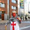 Midget with a red face wearing a St George's Cross, amour suit and crown
promoting 'King Tango' for an adveristing campaign for St Georges Day on the 23rd April.
London, England.