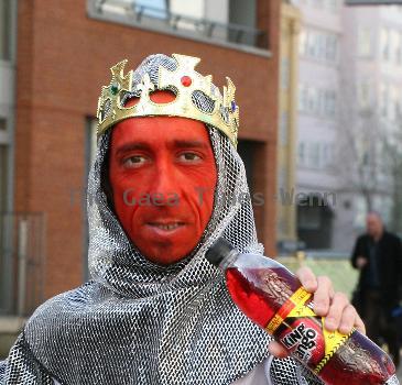 Midget with a red face wearing a St George's Cross, amour suit and crown
promoting 'King Tango' for an adveristing campaign for St Georges Day on the 23rd April.
London, England.