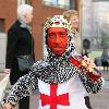 Midget with a red face wearing a St George's Cross, amour suit and crown
promoting 'King Tango' for an adveristing campaign for St Georges Day on the 23rd April.
London, England.