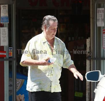 Beach Boys legend Brian Wilson saunters back to his car after buying a bottle of water at a roadside market. 
Los Angeles, California.