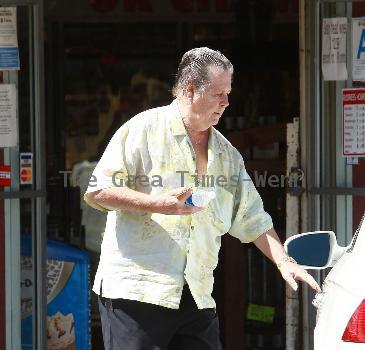 Beach Boys legend Brian Wilson saunters back to his car after buying a bottle of water at a roadside market. 
Los Angeles, California.