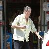 Beach Boys legend Brian Wilson saunters back to his car after buying a bottle of water at a roadside market. 
Los Angeles, California.