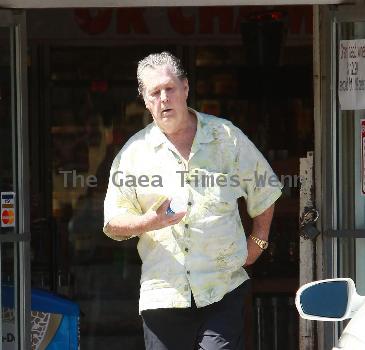 Beach Boys legend Brian Wilson saunters back to his car after buying a bottle of water at a roadside market. 
Los Angeles, California.