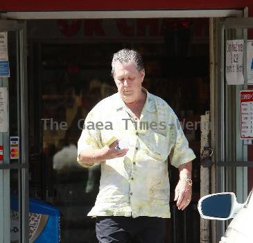 Beach Boys legend Brian Wilson saunters back to his car after buying a bottle of water at a roadside market. 
Los Angeles, California.