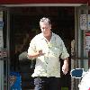 Beach Boys legend Brian Wilson saunters back to his car after buying a bottle of water at a roadside market. 
Los Angeles, California.