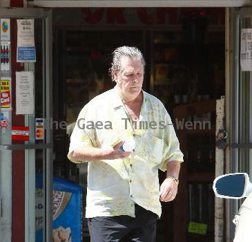 Beach Boys legend Brian Wilson saunters back to his car after buying a bottle of water at a roadside market. 
Los Angeles, California.