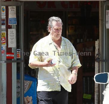 Beach Boys legend Brian Wilson saunters back to his car after buying a bottle of water at a roadside market. 
Los Angeles, California.