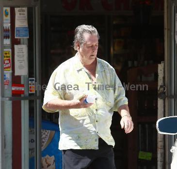 Beach Boys legend Brian Wilson saunters back to his car after buying a bottle of water at a roadside market. 
Los Angeles, California.