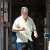 Beach Boys legend Brian Wilson saunters back to his car after buying a bottle of water at a roadside market. 
Los Angeles, California.