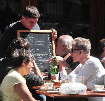 Calvin Klein and friends ordering food at Bar Pitti New York City.